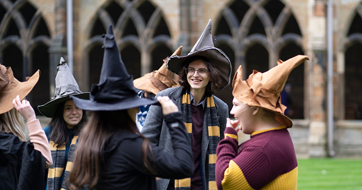 group of young people dressed as wizards and witches inside Durham Cathedral cloisters 